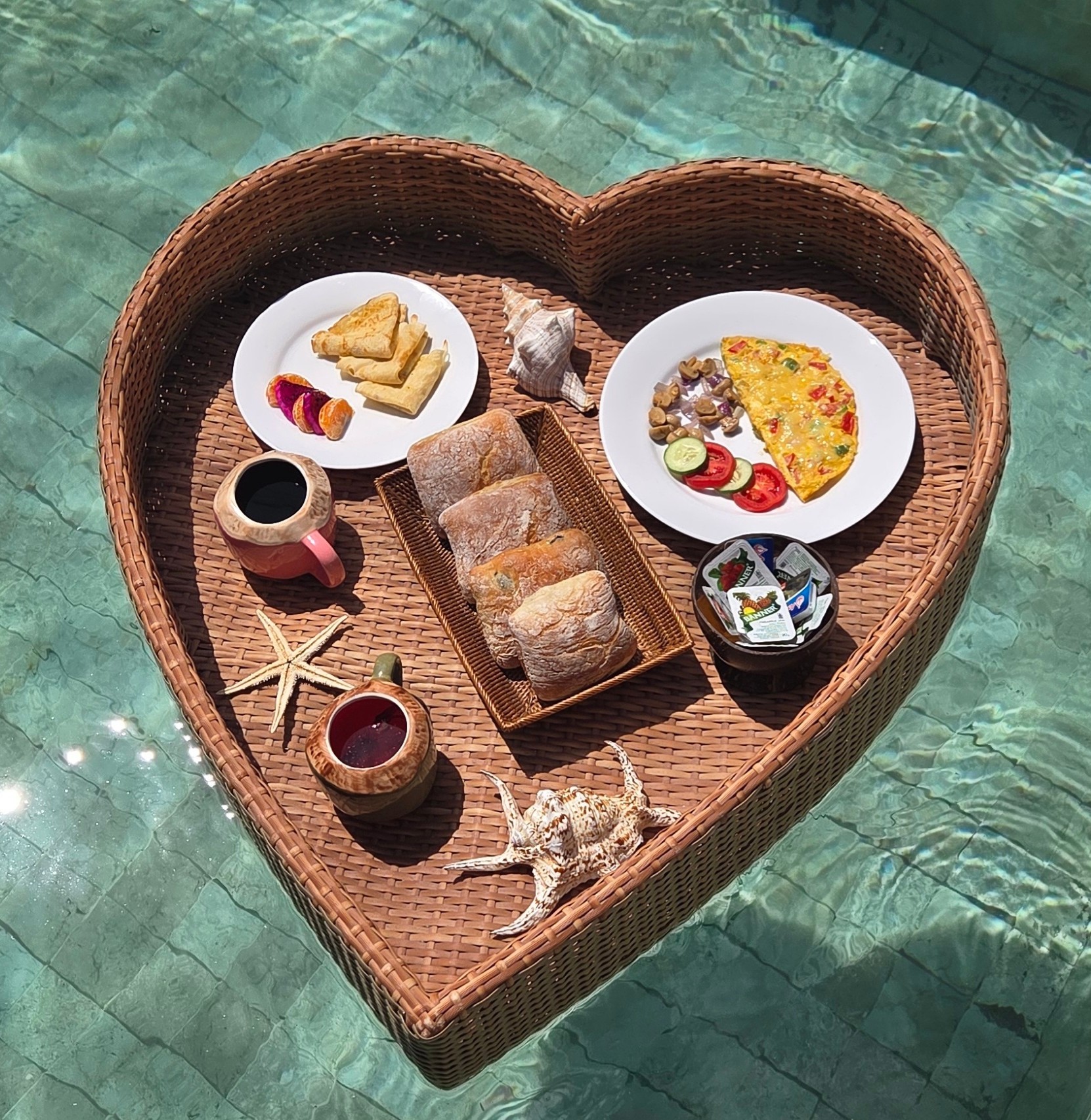 Heart-shaped floating breakfast served in the private pool