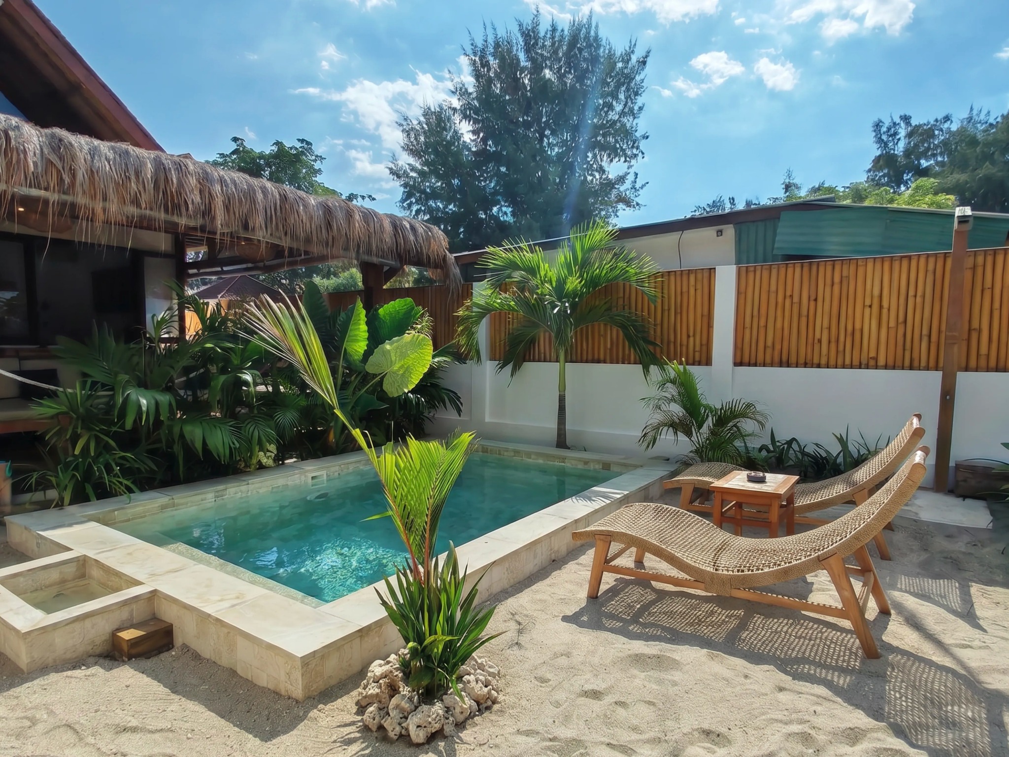 Private swimming pool with loungers and tropical garden