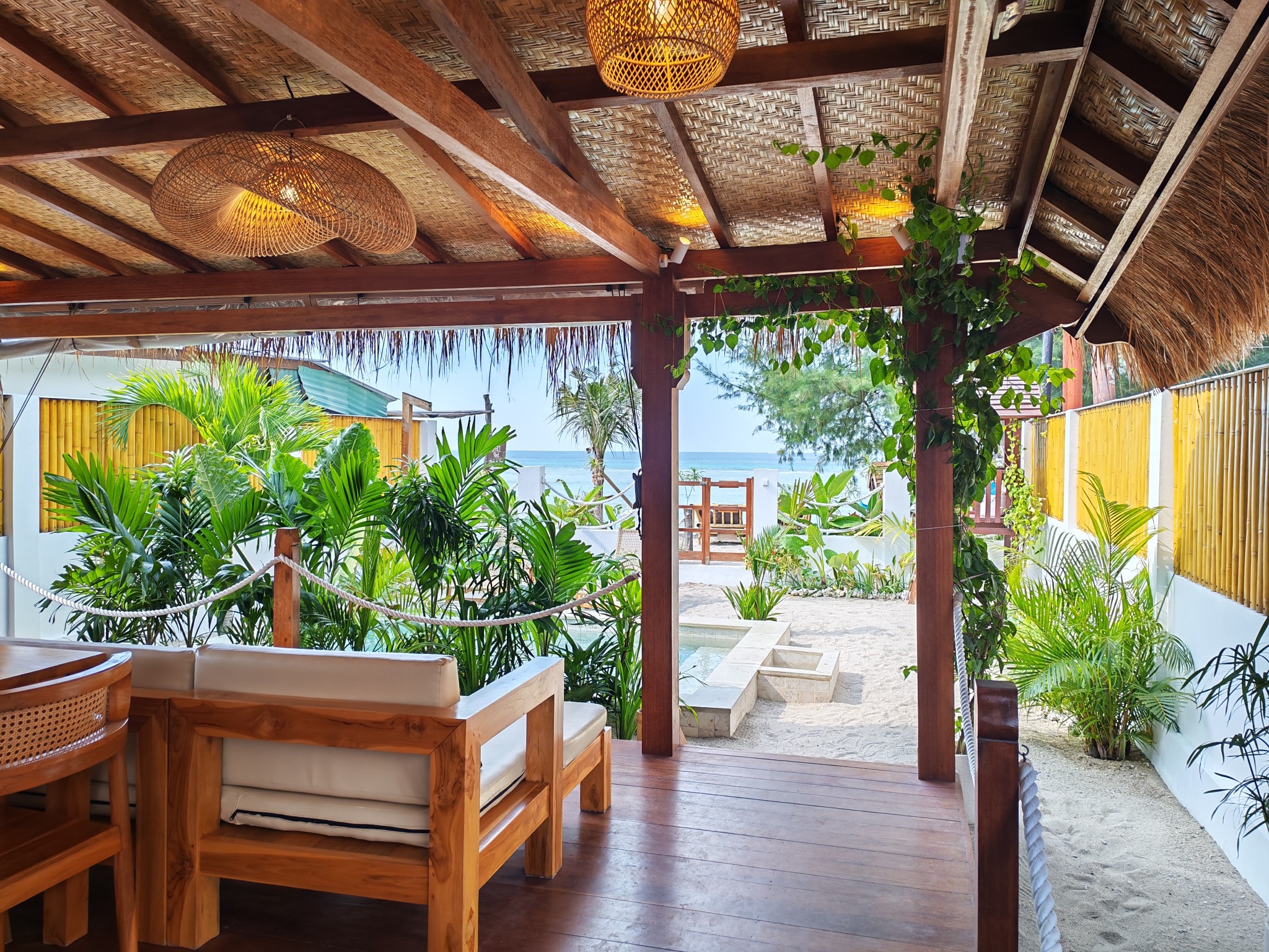 Covered terrace with tropical planting and sea view