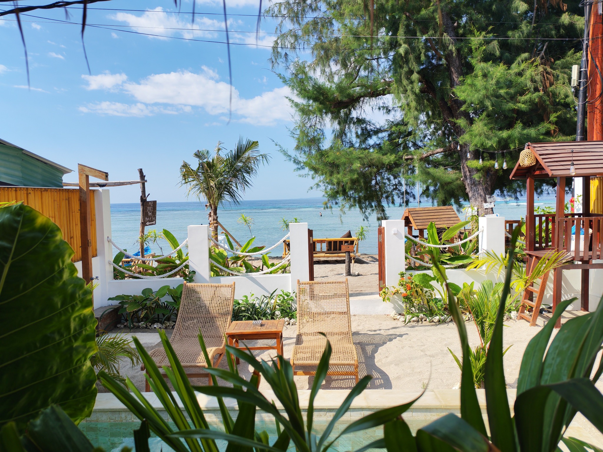 View from the terrace across the pool and garden towards the sea